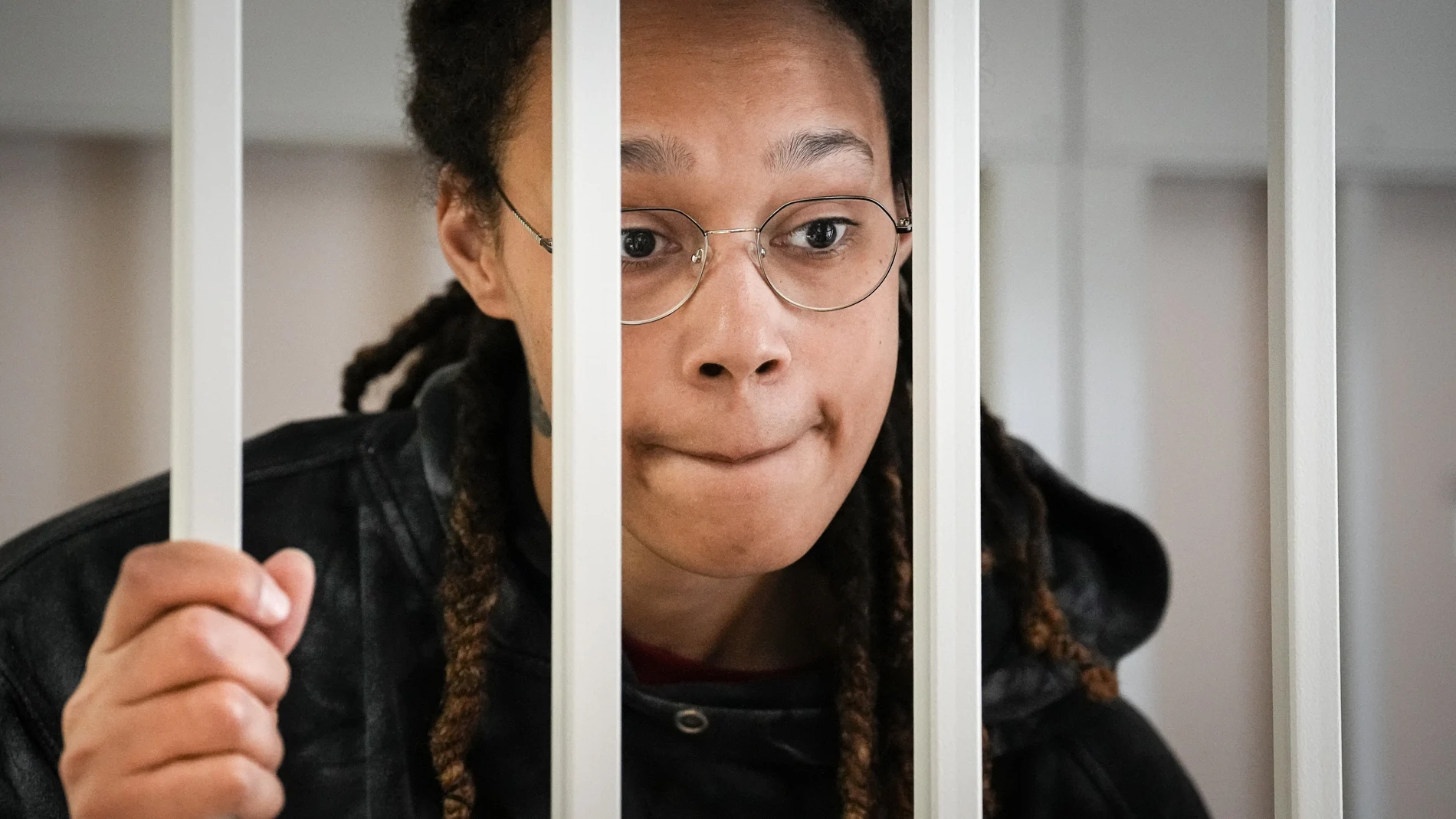 FILE - WNBA star and two-time Olympic gold medalist Brittney Griner speaks to her lawyers standing in a cage at a court room prior to a hearing, in Khimki just outside Moscow, Russia, Tuesday, July 26, 2022. A Russian court has on Tuesday, Oct. 23 started hearing American basketball star Brittney Griner's appeal against her nine-year prison sentence for drug possession. (AP Photo/Alexander Zemlianichenko, Pool, File)