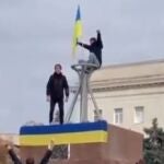 Un grupo de civiles iza la bandera de Ucrania en Jersón