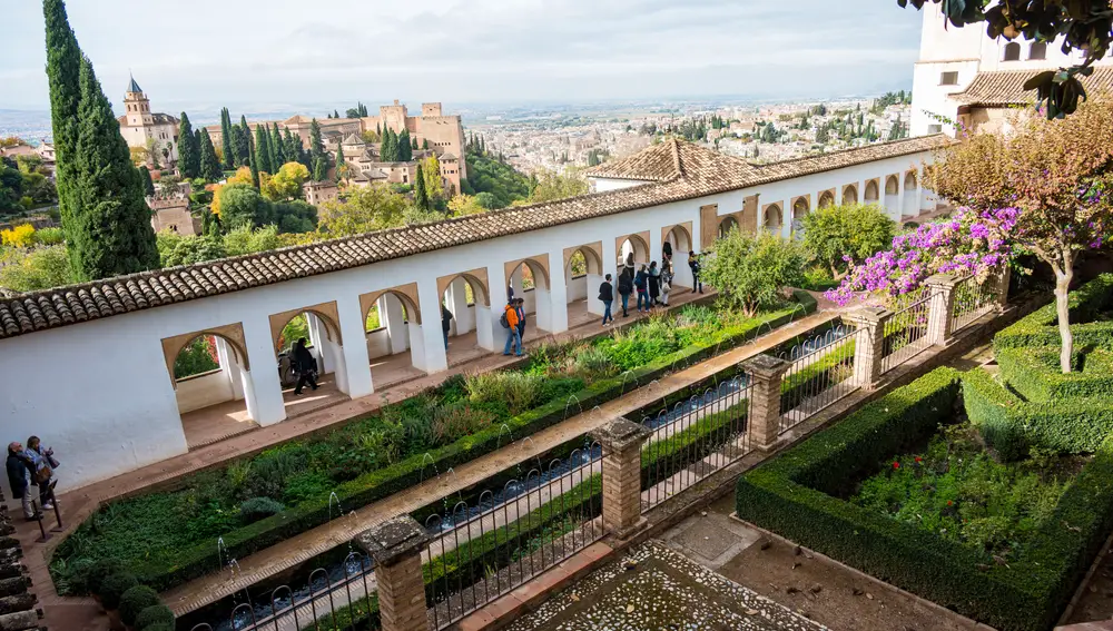 Varios turistas visitan uno de los rincones del amplio conjunto monumental y paisajístico granadino de la Alhambra y el Generalife