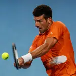 Novak Djokovic se dispone a golpear un revés a dos manos en la final en Adelaida ante Korda