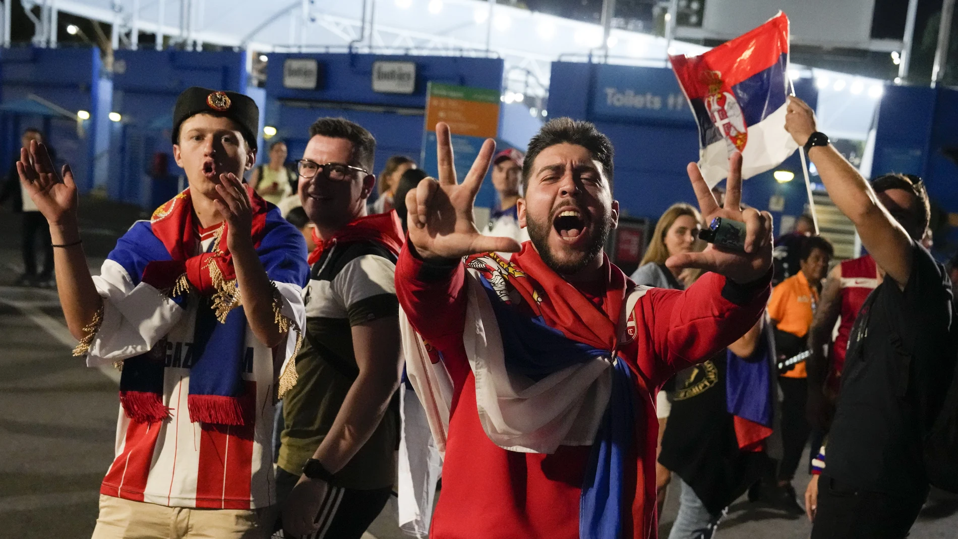 Aficionados serbios celebran en los alrededores de la Rod Laver Arena la victoria de Djokovic ante Tommy Paul