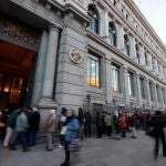 Numerosas personas hace colas ante el Banco de España para comprar deuda pública española, este viernes en Madrid