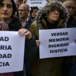 Relatives of people killed by the dissolved basque armed group ETA, brandish banners reading ''True, Memory, Dignity, Justice'', in tribute of their victims, in Pamplona, northern Spain, Friday, Dec. 28, 2018. Every year during Christmas days, relatives of the victims of ETA gather to condemn the actions of the armed group.