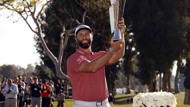Jon Rahm hold the winner's trophy after winning the Genesis Invitational golf tournament at Riviera Country Club, Sunday, Feb. 19, 2023, in the Pacific Palisades area of Los Angeles