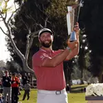 Jon Rahm hold the winner&#39;s trophy after winning the Genesis Invitational golf tournament at Riviera Country Club, Sunday, Feb. 19, 2023, in the Pacific Palisades area of Los Angeles