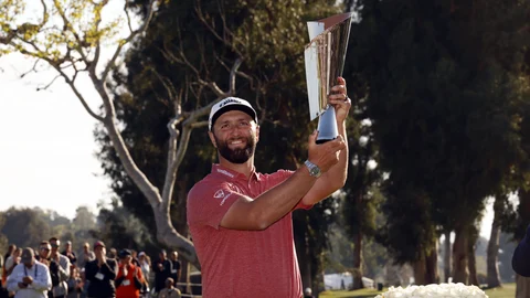 Jon Rahm hold the winner's trophy after winning the Genesis Invitational golf tournament at Riviera Country Club, Sunday, Feb. 19, 2023, in the Pacific Palisades area of Los Angeles