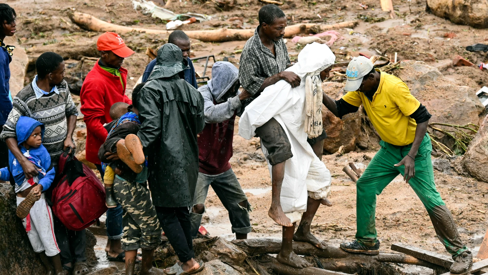 An injured man helped accrossin Blantyre, Malawi, Monday, March 13, 2023. The unrelenting Cyclone Freddy that is currently battering southern Africa has killed more than 50 people in Malawi and Mozambique since it struck the continent for a second time on Saturday night, (AP Photo/Thoko Chikondi)