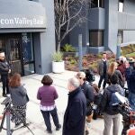 Customers wait outside the headquarters of Silicon Valley Bank (SVB) in Santa Clara, California, USA, 13 March 2023