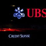 Illuminated logos of the Swiss banks Credit Suisse and UBS