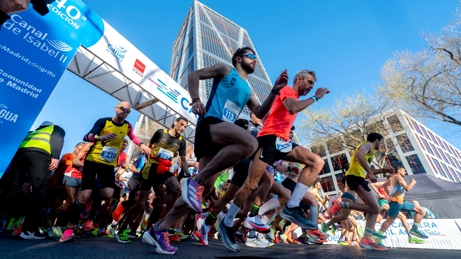 Varios participantes participan en la 40 Carrera del Agua, a 19 de marzo de 2023, en Madrid (España). Madrid se viste de azul en la 40 edición de la Carrera del Agua, organizada por el Canal Isabel II con el fin de sensibilizar sobre la importancia de este recurso vital y en la que participarán más de 2.000 corredores en sus dos distancias de cinco y diez kilómetros. 19 MARZO 2023;CARRERA POPULAR;AGUA;SEQUÍA;DEPORTE;AIRE LIBRE;CORREDORES;RUNNERS;ROPA DEPORTIVA;DORSAL;CORREDORA;CAMISETA TÉCNICA;TORRE KIO;SALIDA;DEPORTIVAS; Alberto Ortega / Europa Press 19/03/2023