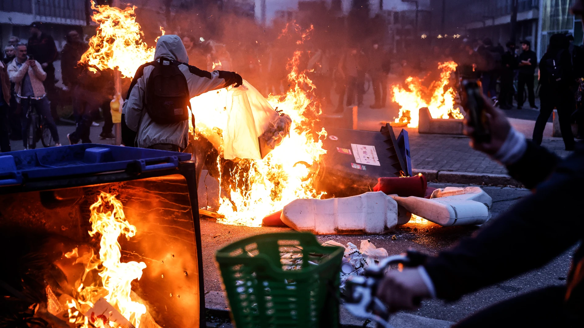 Protesters burn dustbins at the end of a demonstration in Strasbourg, France, Thursday, March 23, 2023. French unions are holding their first mass demonstrations Thursday since President Emmanuel Macron enflamed public anger by forcing a higher retirement age through parliament without a vote. (AP Photo/Jean-Francois Badias)