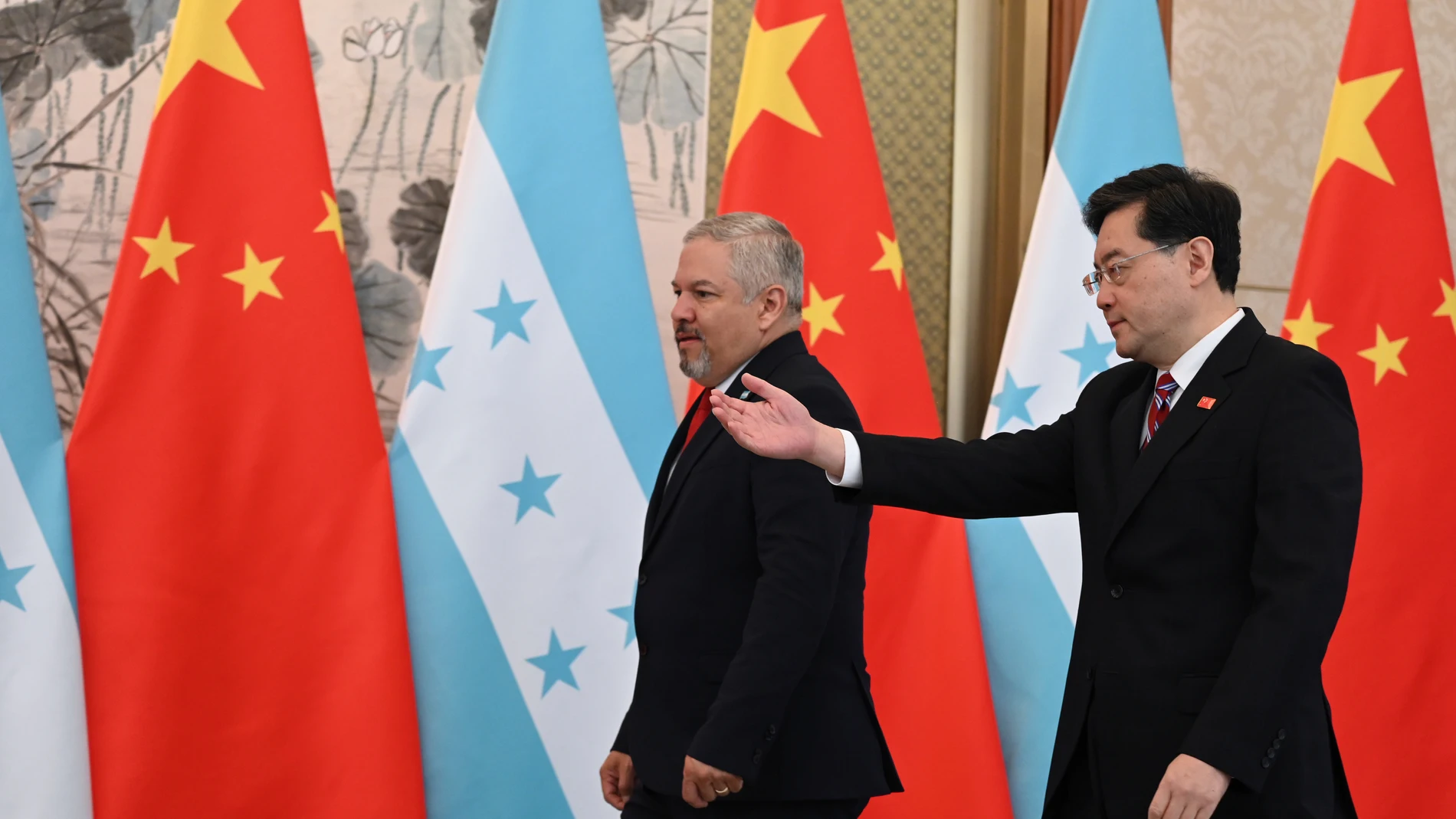 El ministro de Asuntos Exteriores de China, Qin Gang, a la derecha, muestra el camino al ministro de Asuntos Exteriores de Honduras, Eduardo Enrique Reina García