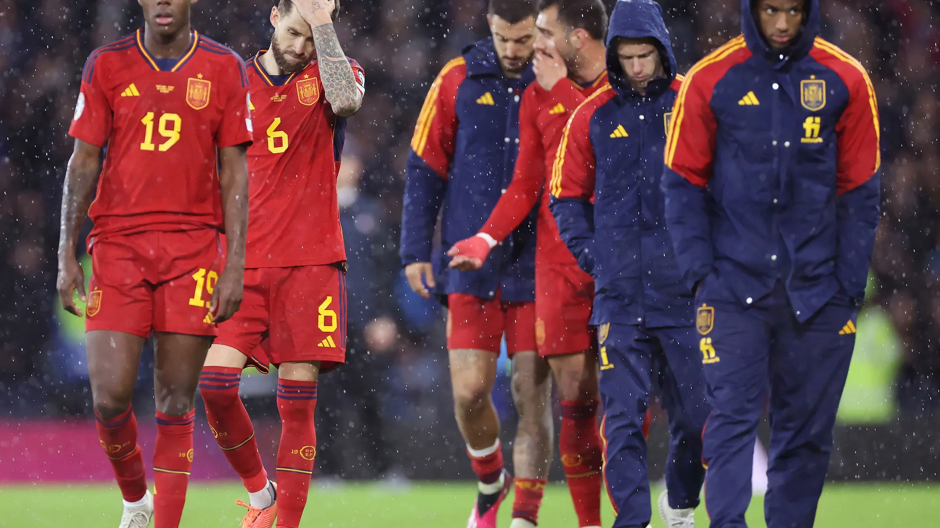 Spain players walk off dejected following a Euro 2024 group A qualifying soccer match between Scotland and Spain at the Hampden Park stadium in Glasgow, Scotland, Tuesday, March 28, 2023. (Steve Welsh/PA via AP)
