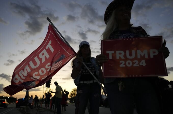 Kathy Clark of Lantana, right, and "Maga" Mary Kelley show their support for former President Donald Trump after the news that Trump has been indicted by a Manhattan grand jury, Thursday, March 30, 2023, near Trump's Mar-a-Lago estate in Palm Beach, Fla.