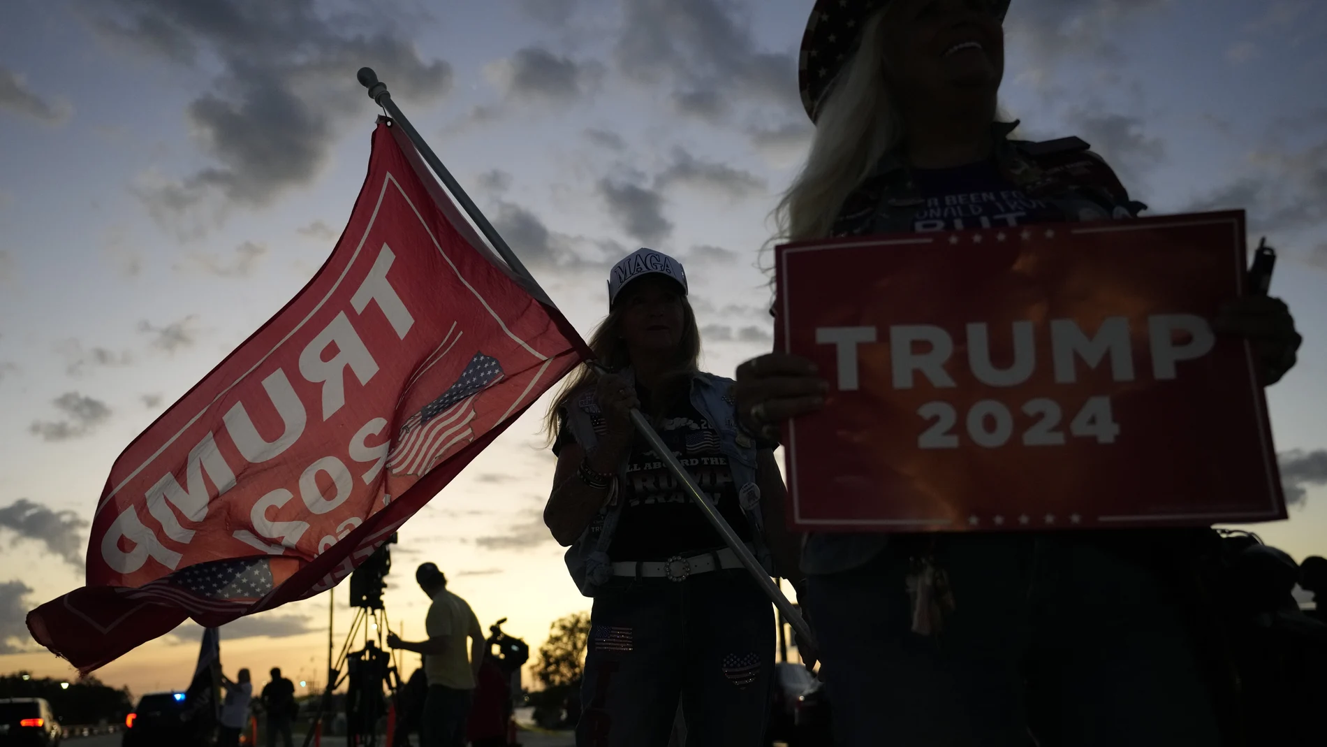Kathy Clark of Lantana, right, and "Maga" Mary Kelley show their support for former President Donald Trump after the news that Trump has been indicted by a Manhattan grand jury, Thursday, March 30, 2023, near Trump's Mar-a-Lago estate in Palm Beach, Fla.