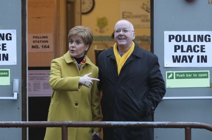 Scottish First Minister Nicola Sturgeon poses for the media with husband Peter Murrell, outside polling station in Glasgow, Scotland. British media are reporting that the husband of former Scottish National Party leader Nicola Sturgeon has been arrested in a party finance probe on Wednesday, April 5, 2023.