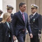 Spain's President Pedro Sanchez, center, and Italian Premier Giorgia Meloni review the honor guard as Sanchez arrives for talks at Chigi government office in Rome Wednesday, April 5, 2023. Sanchez is on the second and last day of his round of consultations that included Cyprus and Malta.