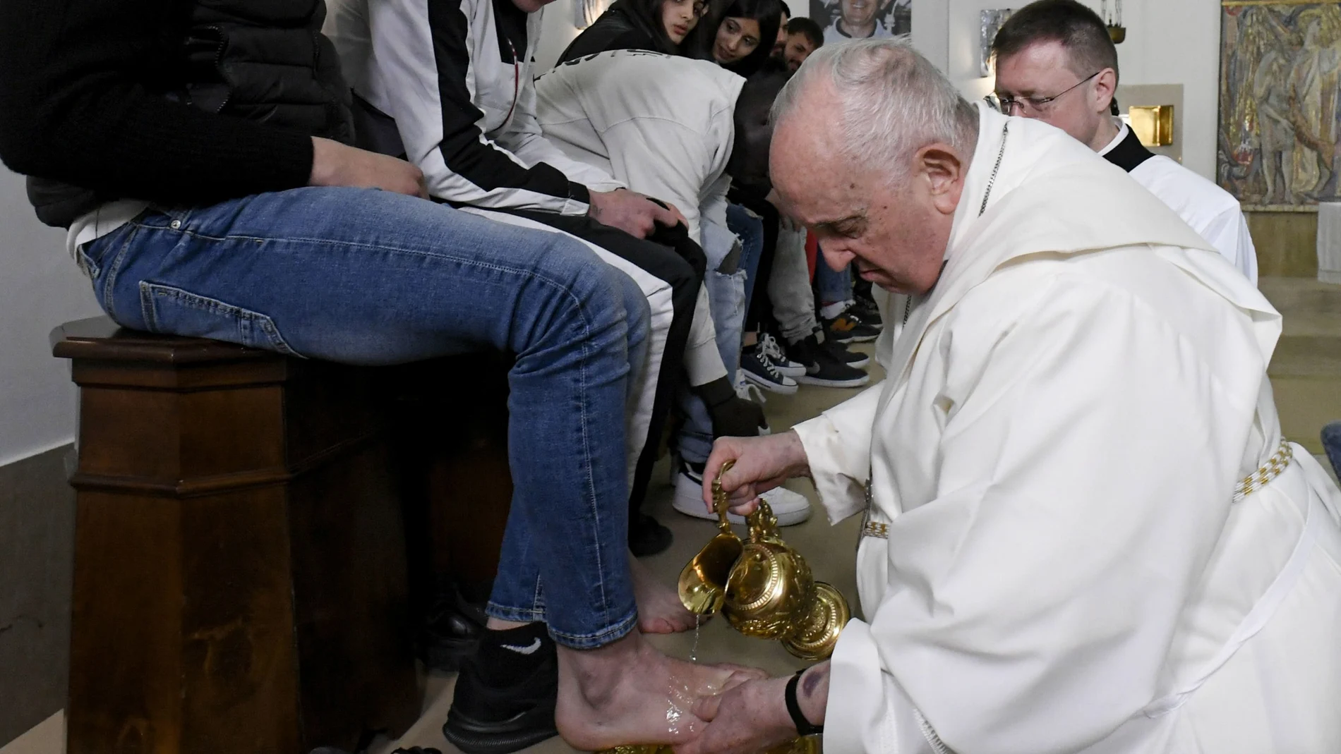 A handout picture provided by the Vatican Media shows Pope Francis performing the rite of the washing of the feet on Holy Thursday in Rome, Italy, 06 April 2023. He washes and kisses the feet of young prisoners that symbolize the apostles.