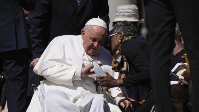 Pope Francis caresses a statuette of the Virgin Mary as he leaves at the end of his weekly general audience in St. Peter's Square, at the Vatican, Wednesday, April 26, 2023.