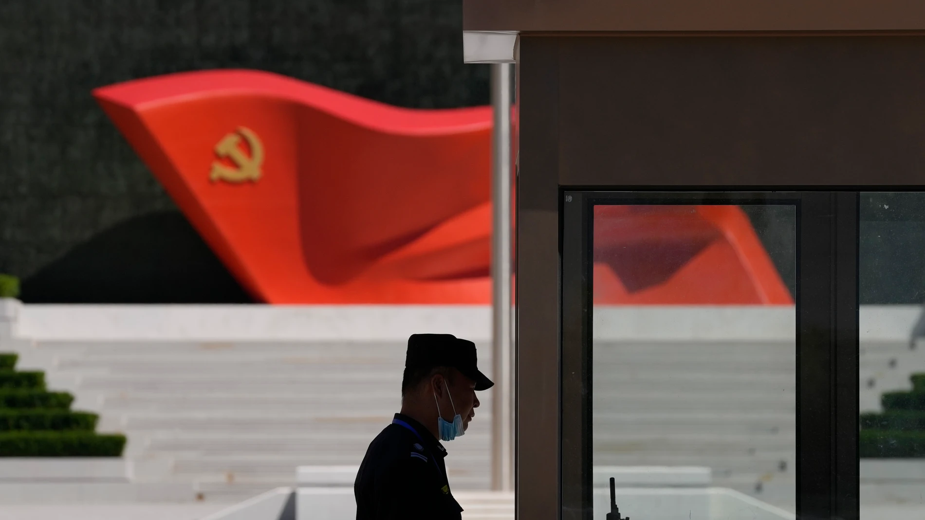 FILE - A security guard stands near a sculpture of the Chinese Communist Party flag at the Museum of the Communist Party of China on May 26, 2022, in Beijing. China’s military flew 38 fighter jets and other warplanes near Taiwan, the Taiwanese defense ministry said Friday, April 28, 2023, in the largest such flight display since the large military exercise in which it simulated sealing off the island earlier in the month. (AP Photo/Ng Han Guan, File)