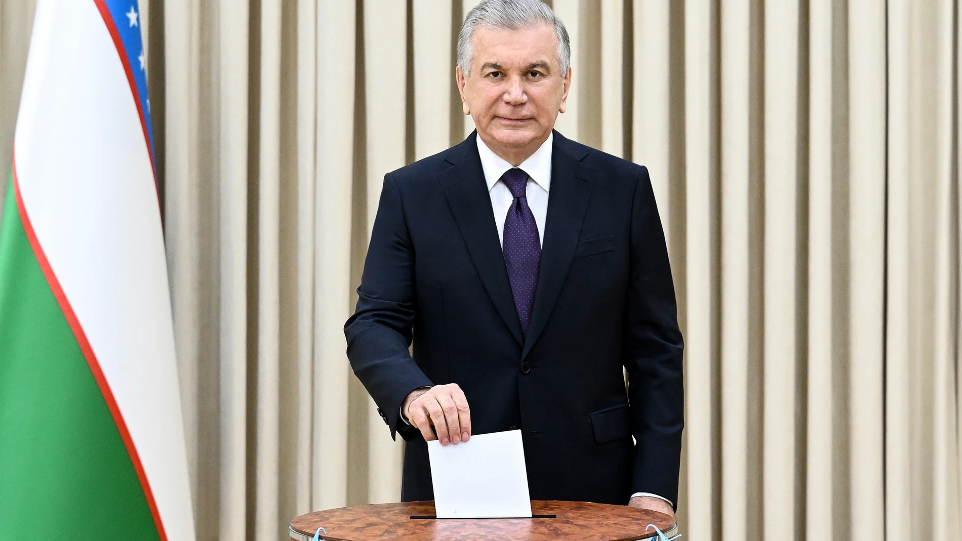 In this handout photo released by Uzbekistan's Presidential Press Office, Uzbekistan's President Shavkat Mirziyoyev casts his ballot at a polling station during a referendum in Tashkent, Uzbekistan, Sunday, April 30, 2023. Voters in Uzbekistan are casting ballots in a referendum on a revised constitution that promises human rights reforms. But the reforms being voted on Sunday also would allow the country's president to stay in office until 2040.(Uzbekistan's Presidential Press Office via AP)