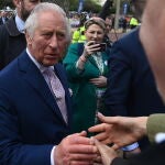 King Charles III and the Prince and Princess of Wales talk to well wishers