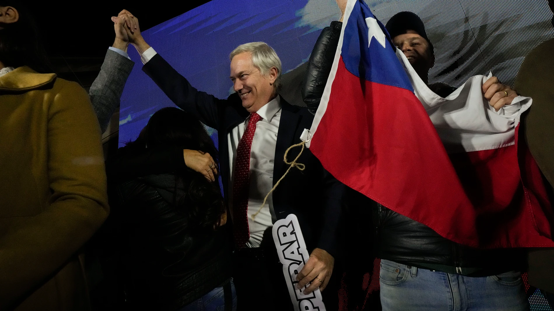 José Antonio Kast, leader of the Republican Party, raises his arm while celebrating obtaining the largest number of representatives after the election for the Constitutional Council, which will draft a new constitution proposal in Santiago, Chile, Sunday, May 7, 2023. A first attempt to replace the current charter bequeathed by the military 42 years ago was rejected by voters during a referendum in 2022. (AP Photo/Esteban Felix)