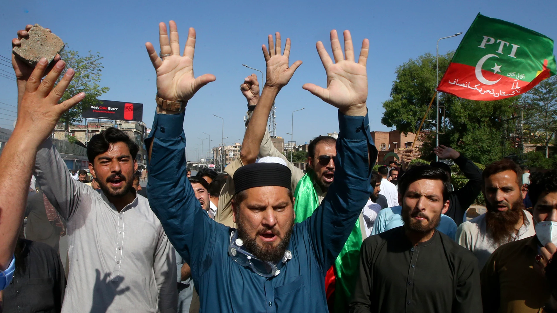 Supporters of Pakistan's former Prime Minister Imran Khan chant slogans as they block a road as a protest to condemn the arrest of their leader, in Peshawar, Pakistan, Tuesday, May 9, 2023. Pakistan's anti-graft agents on Tuesday arrested former Prime Minister Khan as he appeared in a court in the capital, Islamabad, to face charges in multiple graft cases, police and officials from his party said. (AP Photo/Muhammad Sajjad)