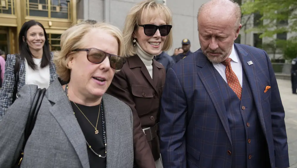 E. Jean Carroll, center, walks out of Manhattan federal court, Tuesday, May 9, 2023, in New York. A jury has found Donald Trump liable for sexually abusing the advice columnist in 1996, awarding her $5 million in a judgment that could haunt the former president as he campaigns to regain the White House.
