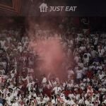 Sevilla's supporters light flares at the end of the UEFA Europa league quarter final second Leg football match between Sevilla and Manchester United at the Ramon Sanchez-Pizjuan stadium in Seville on April 20, 2023. 