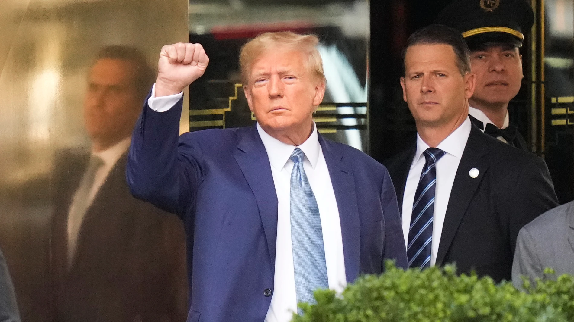 FILE - Former President Donald Trump, left, gestures as he leaves Trump Tower in New York, Thursday, April 13, 2023. The judge in Donald Trump's criminal case is holding a hybrid hearing Tuesday to make doubly sure the former president is aware of new rules barring him from using evidence to attack witnesses. Trump is allowed to speak publicly about the case, but he risks being held in contempt if he uses evidence turned over by prosecutors in the pretrial discovery process to target witnesses or others involved in the case. (AP Photo/Seth Wenig)