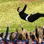 Barcelona players throw their head coach Xavi Hernandez in the air celebrating after being handed the championship at the end of a Spanish La Liga soccer match between Barcelona and Real Sociedad at Camp Nou stadium in Barcelona, Spain, Saturday, May 20, 2023. Barcelona clinched the Spanish league title last Sunday with four rounds still to be played.