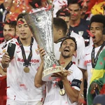Sevilla's Jesus Navas holds the trophy after winning the Europa League final soccer match between Sevilla and Inter Milan in Cologne, Germany, Friday, Aug. 21, 2020.