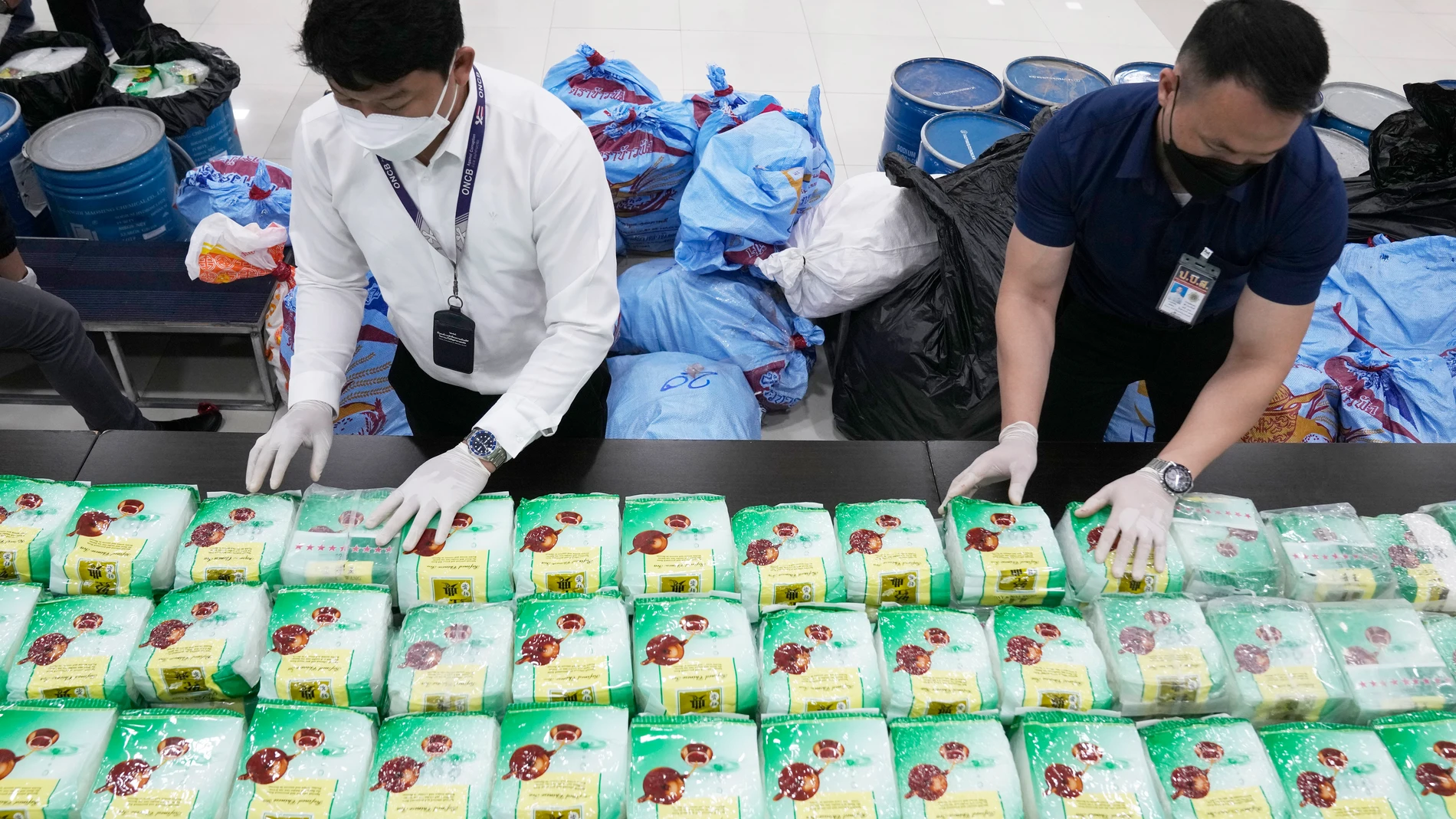 Thai officers display seized crystal methamphetamine which were disguised as packages of tea during a news conference in Bangkok, Thailand, Thursday, June 1, 2023. The huge trade in illegal drugs originating from a small corner of Southeast Asia shows no signs of slowing down, the United Nations Office on Drugs and Crime warned Friday. (AP Photo/Sakchai Lalit)