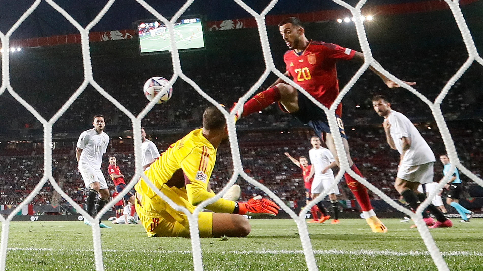 Spain's Joselu scores the decisive last goal against Italy goalkeeper Gianluigi Donnarumma during the Nations League semifinal soccer match between Spain and Italy in Enschede, Netherlands, Thursday June 15, 2023. (AP Photo/Martin Meissner
