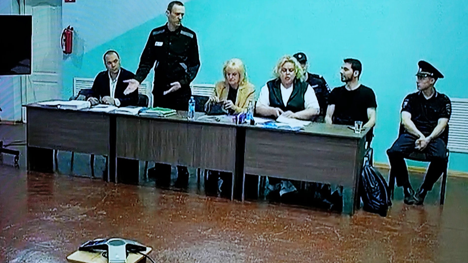 A vies of a TV Screen showing Russian opposition leader Alexei Navalny, 2nd left sitting between his lawyers in a courtroom, via video link provided by the Russian Federal Penitentiary Service, during a preliminary hearing, in Melekhovo, Vladimir region, about 260 kilometers (163 miles) northeast of Moscow, Russia, on Monday, June 19, 2023. A Russian court has opened a new trial of imprisoned Russian opposition leader Alexei Navalny that could keep him behind bars for decades. (AP Photo/Alexa...