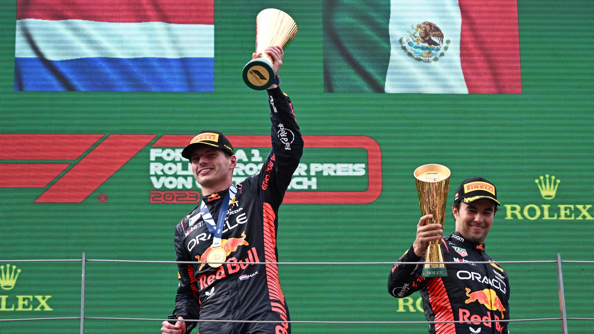 Spielberg (Austria), 02/07/2023.- First placed Dutch Formula One driver Max Verstappen (L) of Red Bull Racing and third placed Mexican teammate Sergio Perez (R) celebrate with the trophies on the podium after the Formula 1 Austrian Grand Prix at the Red Bull Ring race track in Spielberg, Austria, 02 July 2023. (Fórmula Uno) EFE/EPA/CHRISTIAN BRUNA 