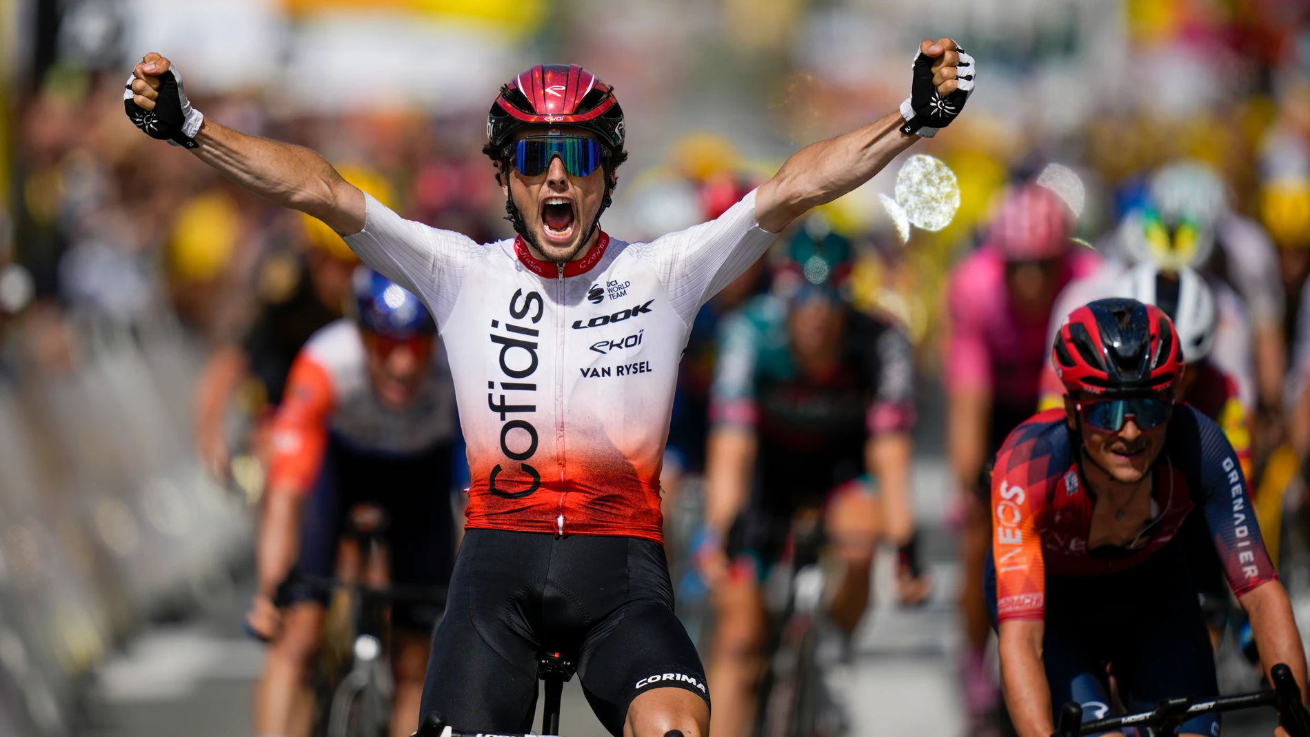 France's Victor Lafay crosses the finish line ahead of fourth place Britain's Thomas Pidcock, right, to win the second stage of the Tour de France cycling race over 209 kilometers (130 miles) with start in Vitoria Gasteiz and finish in San Sebastian, Spain, Sunday, July 2, 2023. (AP Photo/Daniel Cole)