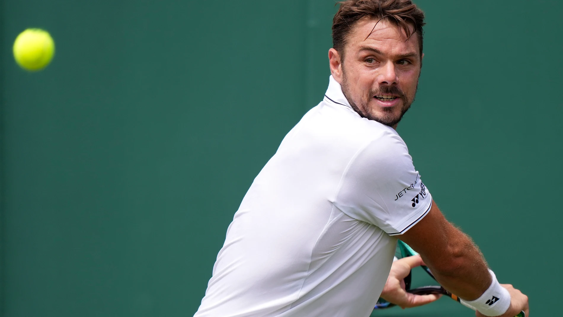 Switzerland's Stan Wawrinka returns to Argentina's Tomas Martín Etcheverry in a men's singles match on day four of the Wimbledon tennis championships in London, Thursday, July 6, 2023. (AP Photo/Alberto Pezzali)