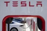Tesla vehicles charge at a station in Emeryville, Calif.