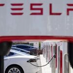 Tesla vehicles charge at a station in Emeryville, Calif.