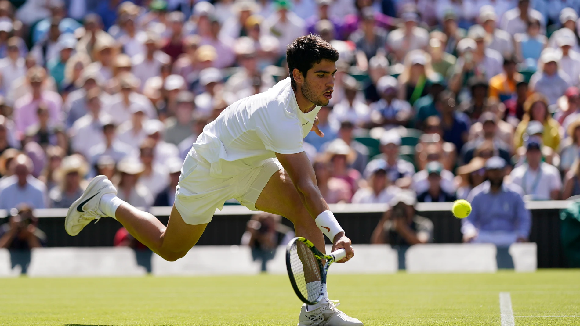 Spain's Carlos Alcaraz returns to Alexandre Muller of France in a men's singles match on day five of the Wimbledon tennis championships in London, Friday, July 7, 2023. (AP Photo/Alberto Pezzali)