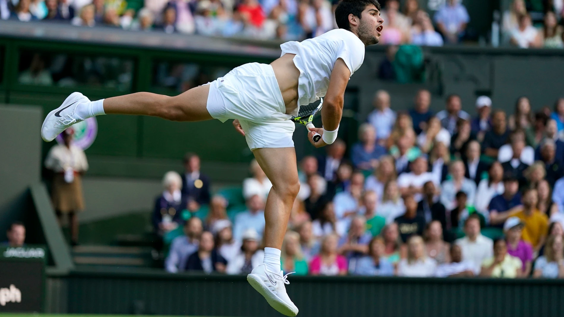 Spain's Carlos Alcaraz serves to Italy's Matteo Berrettini in a men's singles match on day eight of the Wimbledon tennis championships in London, Monday, July 10, 2023. (AP Photo/Alberto Pezzali)