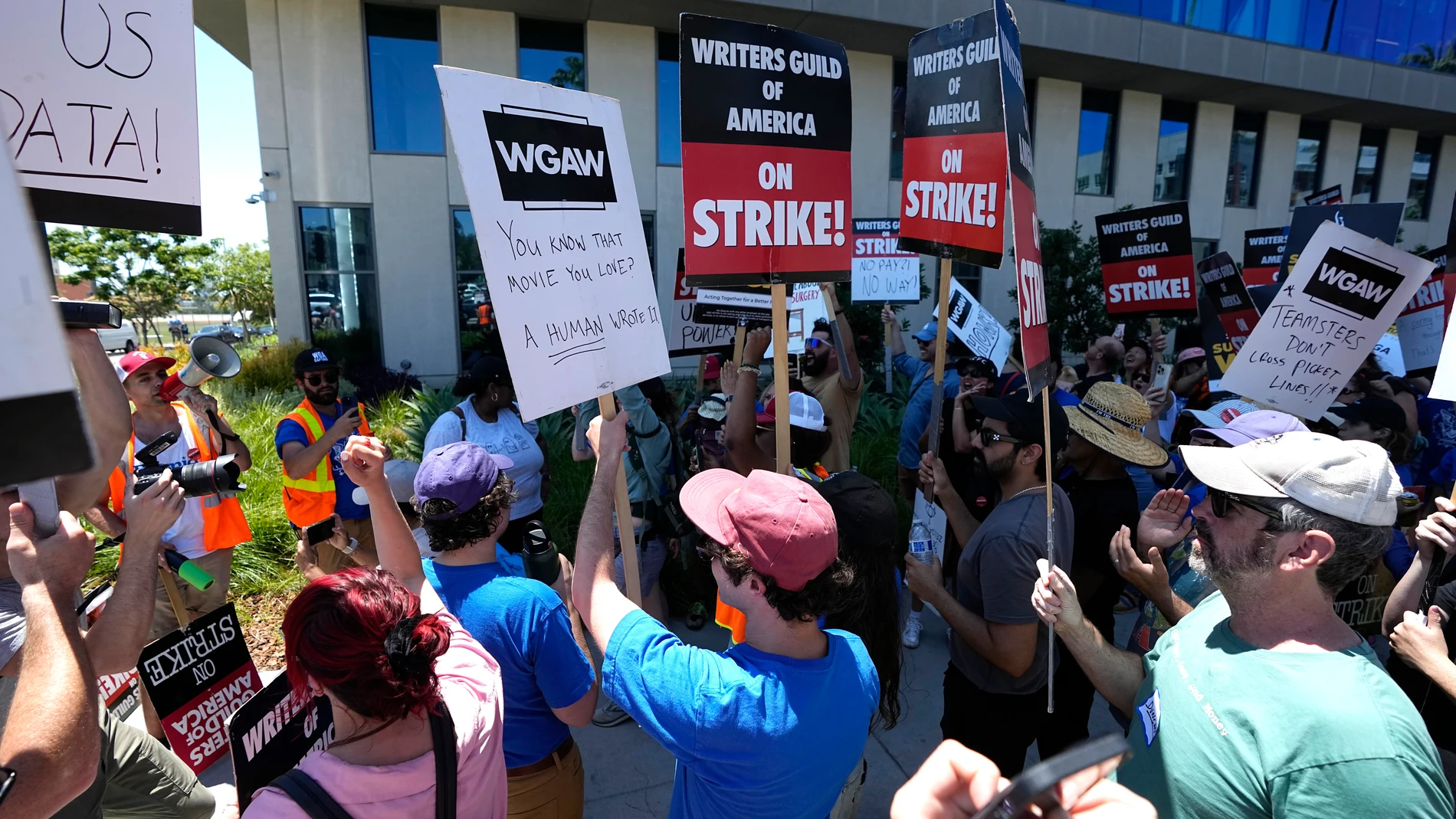 Picketers celebrate outside Netflix during a Writers Guild rally as a strike by The Screen Actors Guild-American Federation of Television and Radio Artists is announced on Thursday, July 13, 2023, in Los Angeles. This marks the first time since 1960 that actors and writers will picket film and television productions at the same time. (AP Photo/Mark J. Terrill)