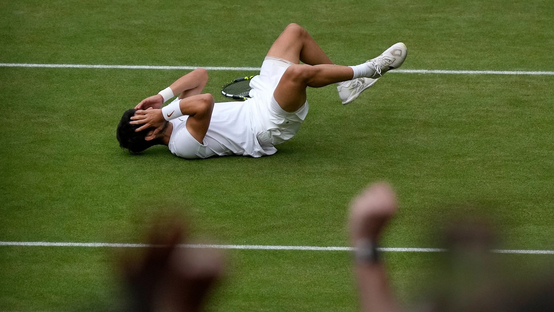 Spain's Carlos Alcaraz celebrates after beating Serbia's Novak Djokovic to win the final of the men's singles on day fourteen of the Wimbledon tennis championships in London, Sunday, July 16, 2023. (AP Photo/Alastair Grant)