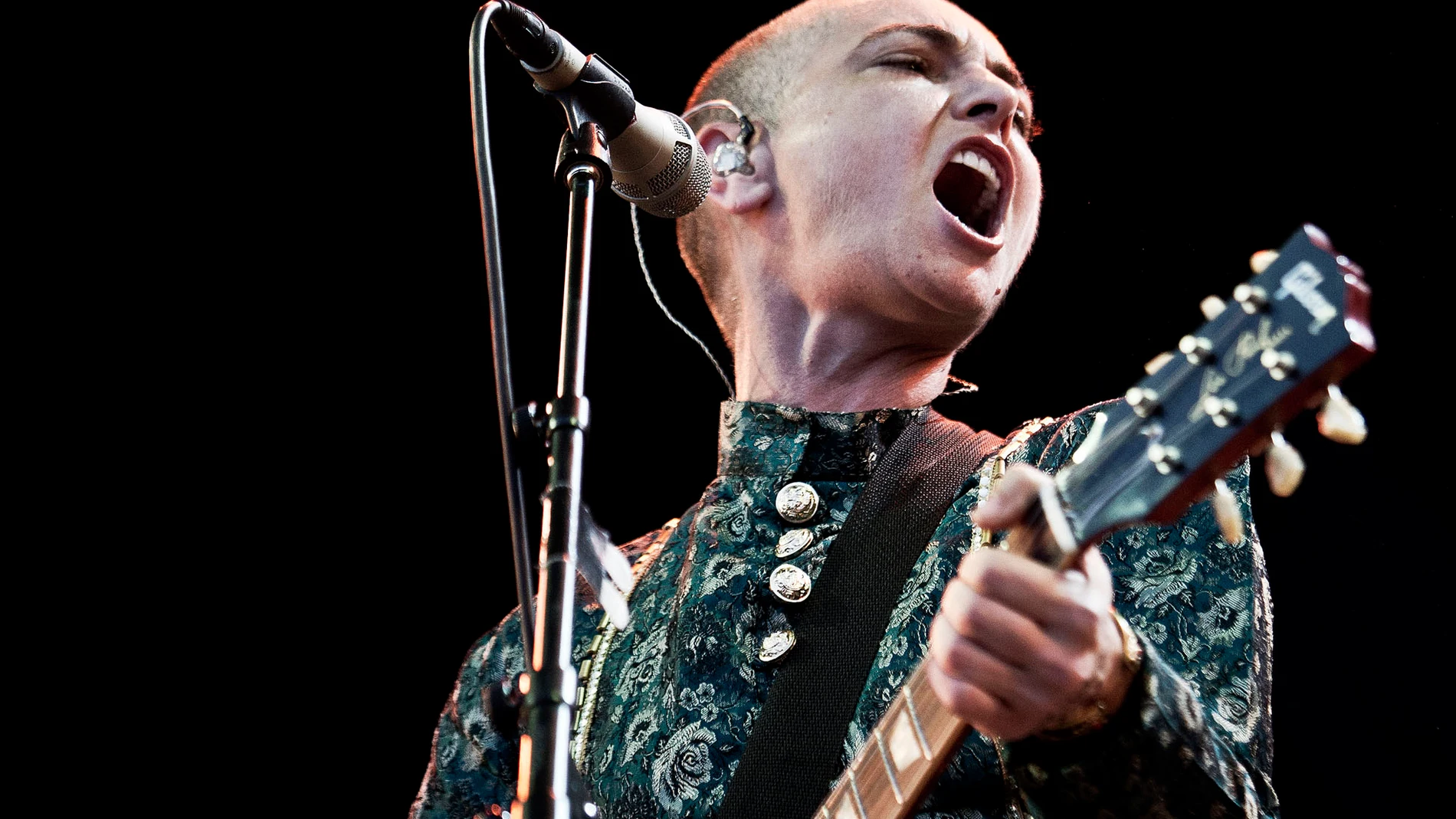 FILE - Irish singer-songwriter Sinéad O'Connor in concert on the first night of the Toender Folk Music Festival in Toender, on the south western part of Denmark on Aug. 23, 2013. O’Connor, the gifted Irish singer-songwriter who became a superstar in her mid-20s but was known as much for her private struggles and provocative actions as for her fierce and expressive music, has died at 56. The singer's family issued a statement reported Wednesday by the BBC and RTE. (AP Photo/Casper Dalhoff, Pol...