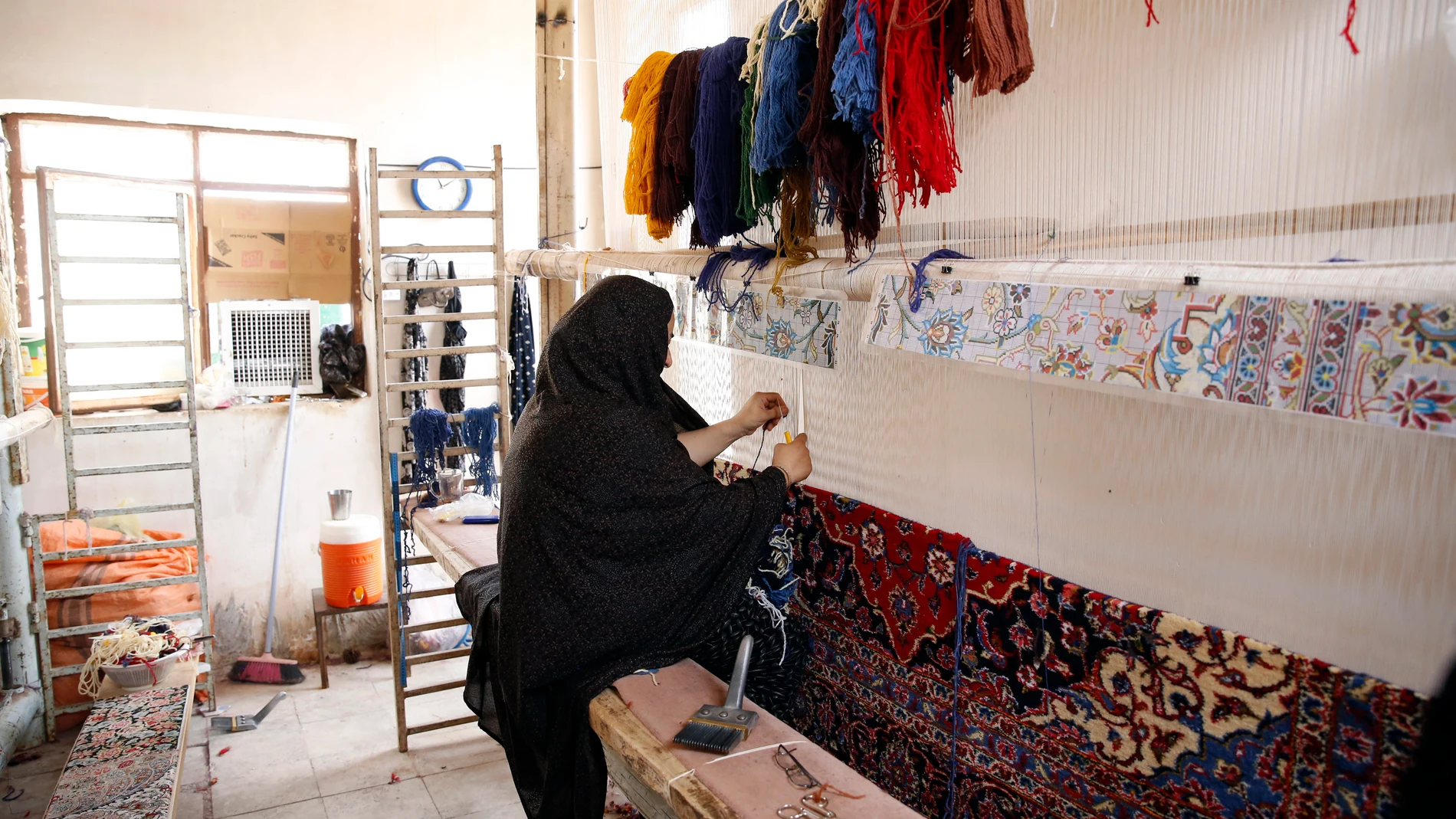 Nushabad (Iran(islamic Republic Of)), 26/07/2023.- An Iranian woman is crafting a handmade carpet in a weaving workshop in a house in Nushabad, Kashan province, central Iran, 26 July 2023 (issued 27 July 2023). Handmade carpets from Kashan are renowned in the country and around the world. However, Iran's carpet industry has been impacted due to the sanctions imposed on Iran because of its nuclear program. Iran used to be a significant exporter of handmade carpets globally. EFE/EPA/ABEDIN TAHE...