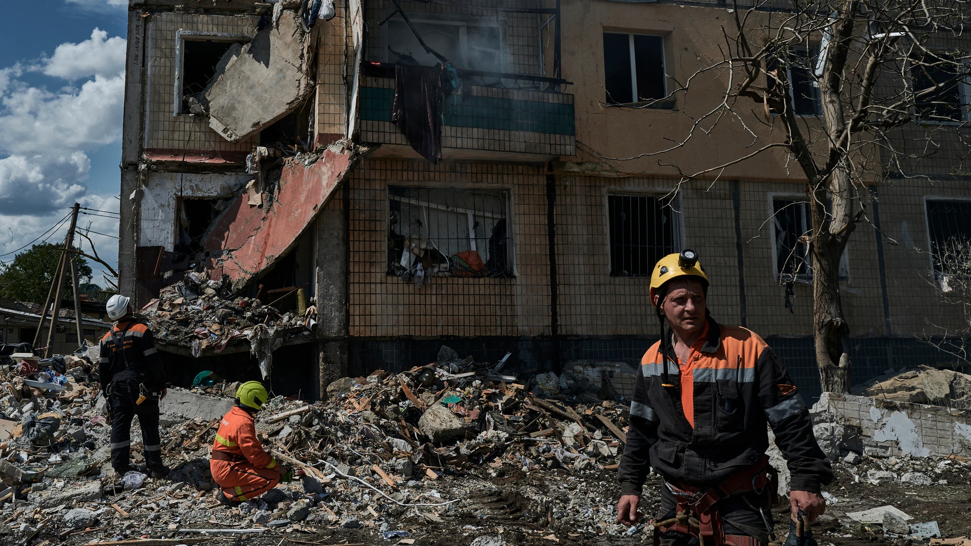 Emergency services work at a scene after a missile hit an apartment building in Kryvyi Rih, Ukraine, Monday, July 31, 2023. (AP Photo/Libkos)