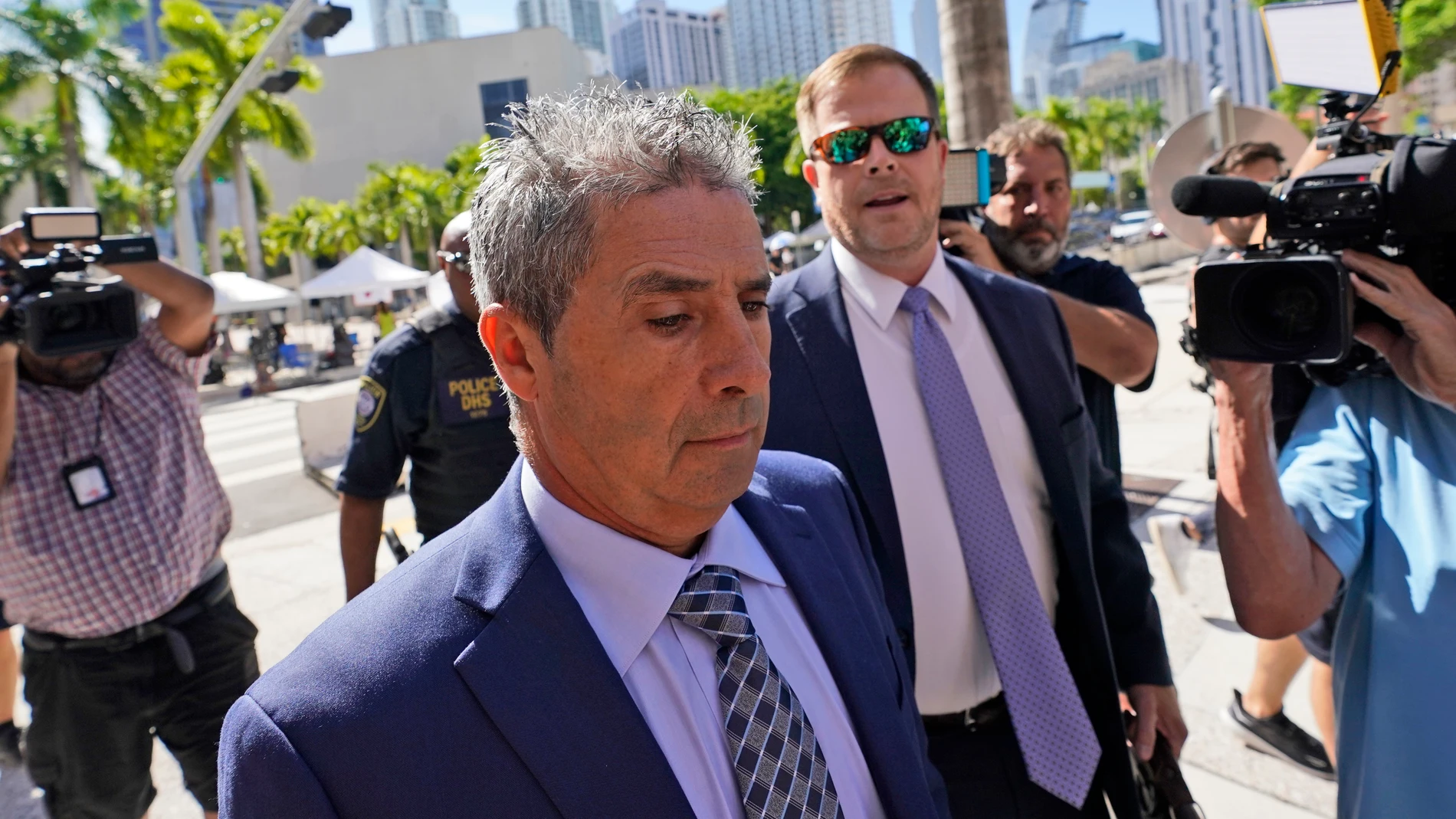 Carlos De Oliveira, center, an employee of Donald Trump's Mar-a-Lago estate, arrives for a court appearance with attorney John Irving, at the James Lawrence King Federal Justice Building, Monday, July 31, 2023, in Miami. De Oliveira, Mar-a-Lago's property manager, was added last week to the indictment with Trump and the former president's valet, Walt Nauta, in the federal case alleging a plot to illegally keep top-secret records at Trump's Florida estate and thwart government efforts to retri...