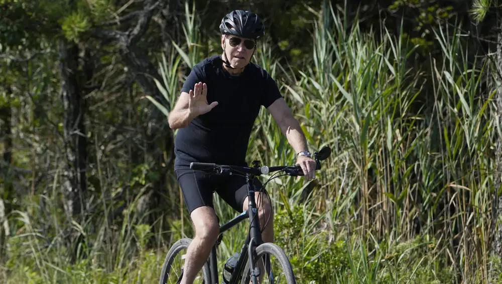 President Joe Biden rides a bike on a path at Gordons Pond in Rehoboth Beach, Del., Wednesday, Aug. 2, 2023.